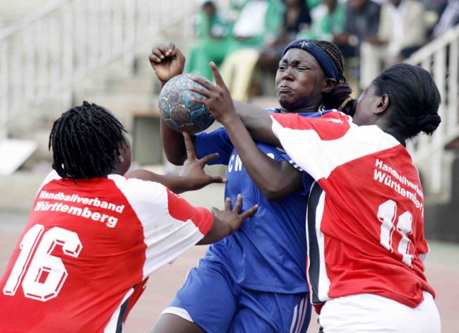 National Cereals Produce Board Vallary Akinyi is tackled by NairobiWater Merlyn Anyi and Judith Ougo during their Handball finals atNyayo Stadium.(Photo by Shutterspeed)