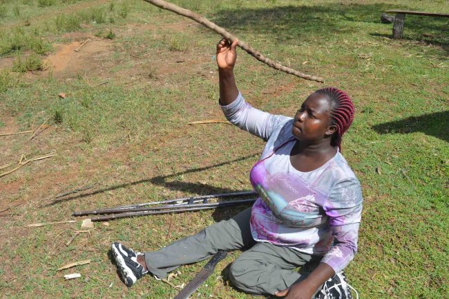 Nelly Sile with her home made Javelin throws.(Photo by Emmanuel Sabuni)