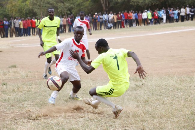 Kathungi's James Mutia attempts to go past Nyiro Boys' Peter Mareri.