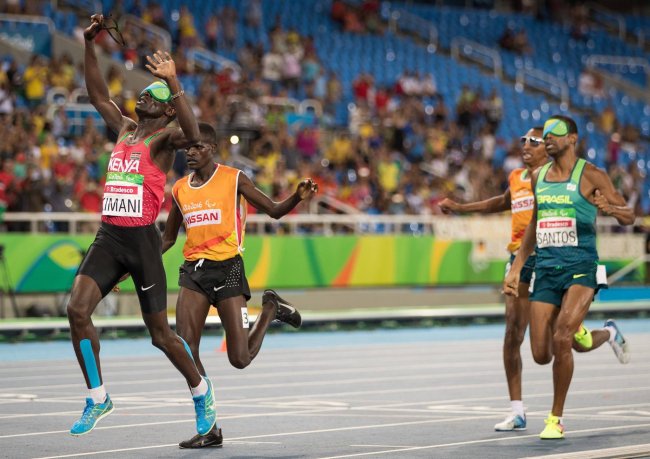 Kenya's Samwel Muchai Kimani with his guide James Boit wins the Gold Medal in the Men's 1500m - T11 Final. Athletics in the Olympic Stadium on September,13.(Photo:Al Tielemans/OIS/IOC)